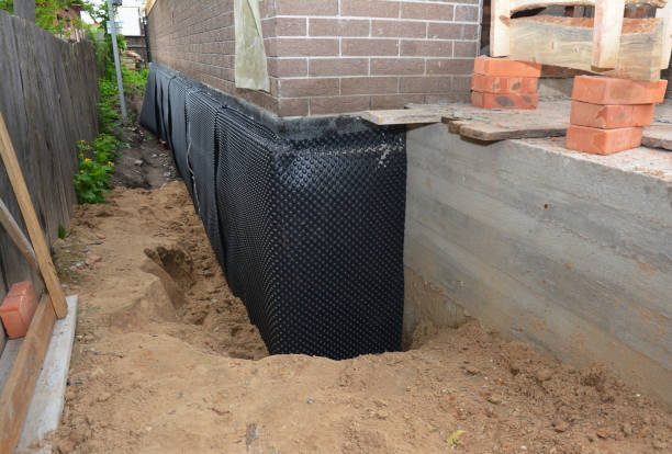 SJ Waterproofing Pros technician performing targeted Waterproofing assessment in Axis, AL